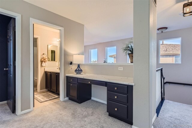 bathroom featuring carpet flooring, vanity, and baseboards