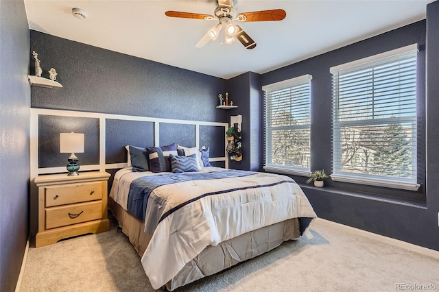 bedroom with carpet, ceiling fan, and baseboards