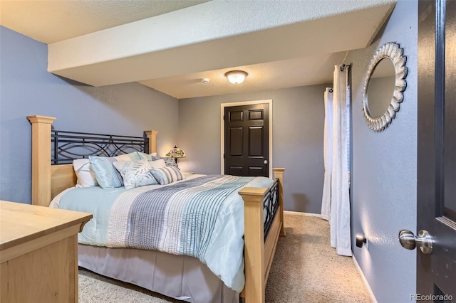 bedroom with light carpet and baseboards