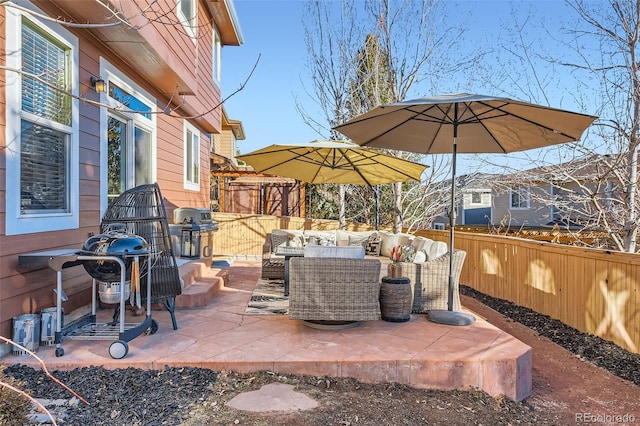 view of patio / terrace with a grill, fence, and outdoor lounge area