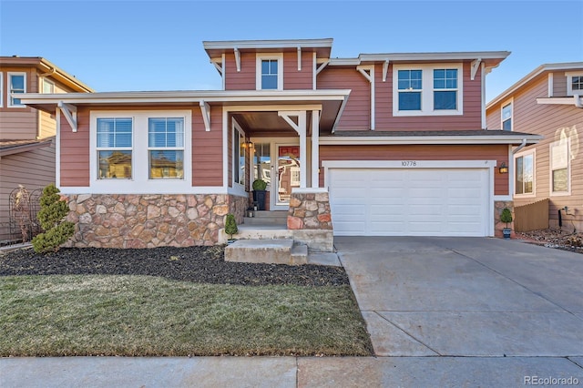 view of front facade featuring an attached garage, driveway, and stone siding