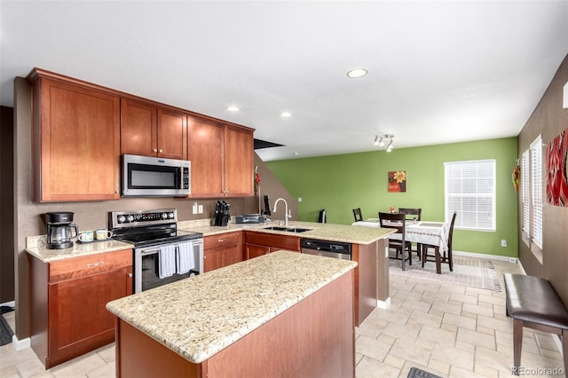 3505 Dinosaur St, Castle Rock, CO 80109 - kitchen featuring stainless steel appliances, a peninsula, a center island, recessed lighting, and light stone counters