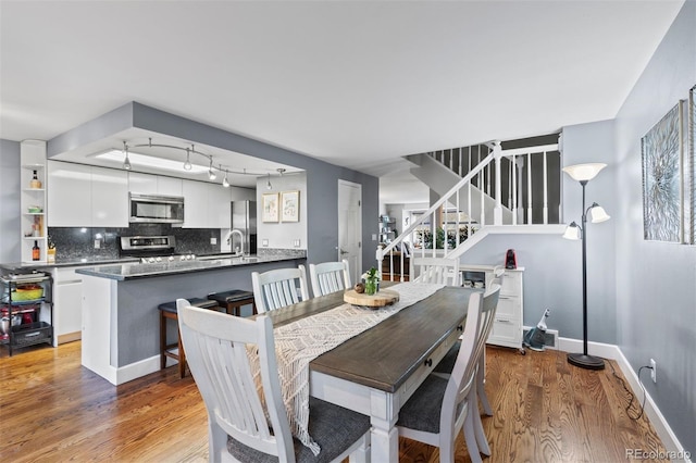 dining area with hardwood / wood-style floors and sink