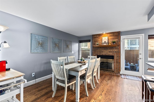 dining area with a fireplace and dark hardwood / wood-style flooring