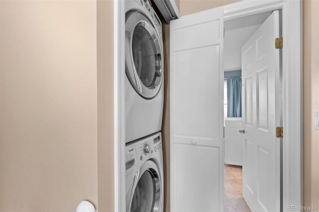 laundry room with stacked washer and dryer