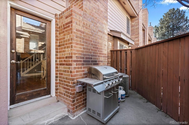 view of patio featuring a grill and central AC unit