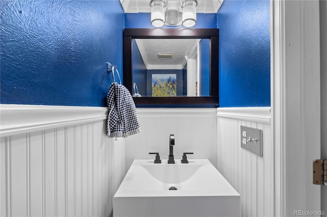 bathroom featuring vanity and ornamental molding