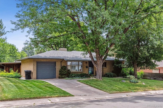 view of front of property with a garage and a front yard