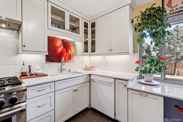 kitchen with white cabinetry, sink, backsplash, and dishwasher