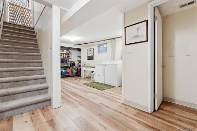 interior space featuring wood-type flooring and washing machine and clothes dryer