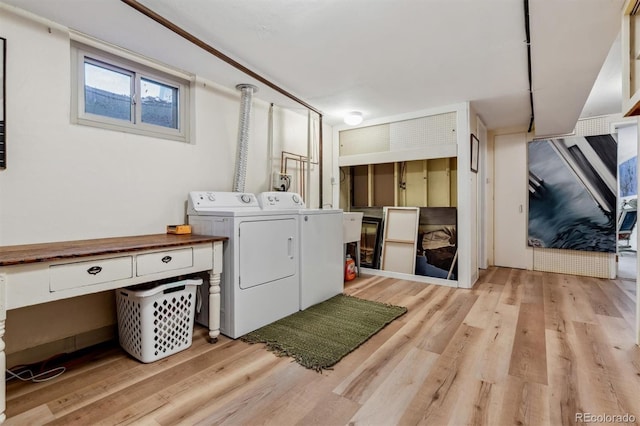 washroom with washer and clothes dryer and light hardwood / wood-style floors