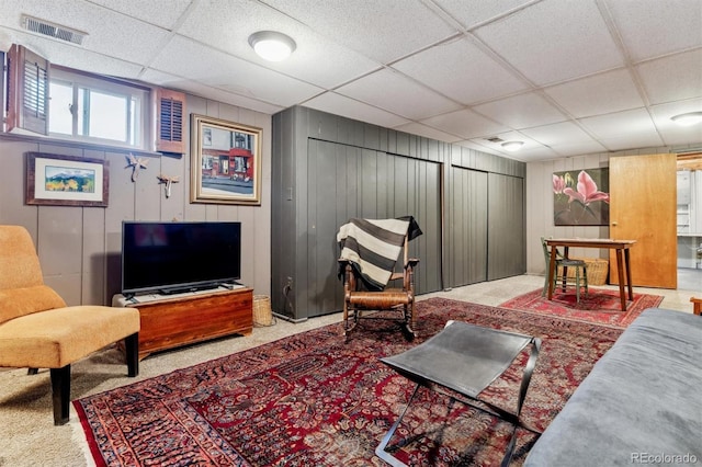 living room featuring a paneled ceiling