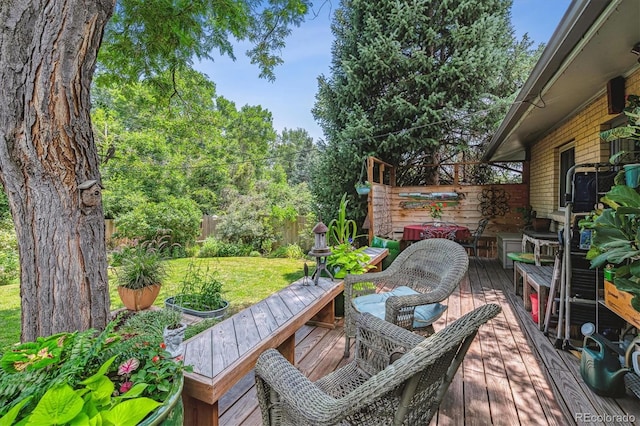 wooden terrace featuring a lawn