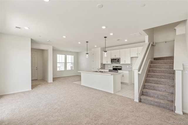 13458 E 111th Ave, Commerce City, CO 80022 - kitchen featuring stainless steel appliances, light carpet, a sink, recessed lighting, and white cabinets