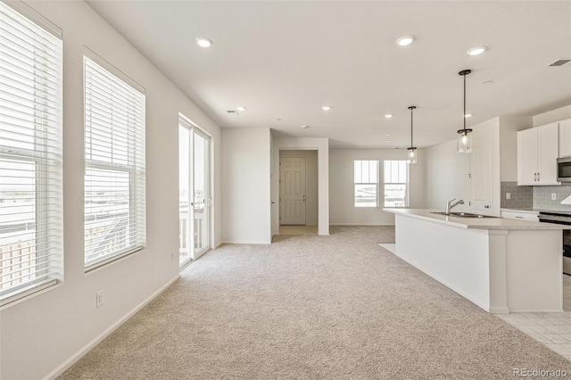 13458 E 111th Ave, Commerce City, CO 80022 - kitchen featuring stainless steel appliances, a sink, recessed lighting, white cabinetry, and light colored carpet