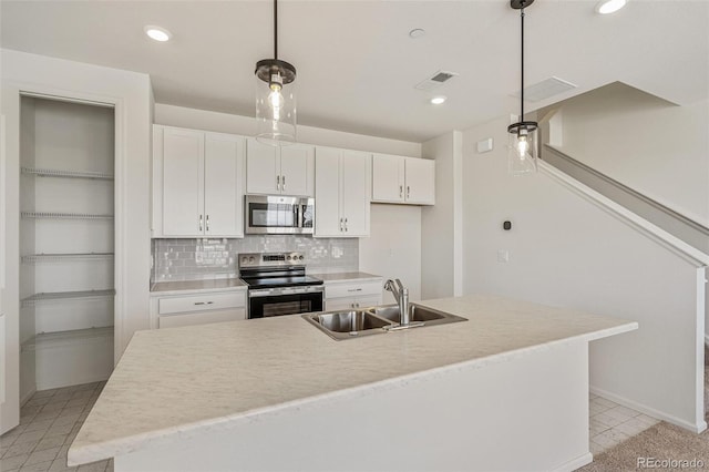 13458 E 111th Ave, Commerce City, CO 80022 - kitchen with stainless steel appliances, a sink, white cabinets, decorative light fixtures, and backsplash