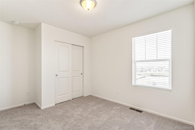 13458 E 111th Ave, Commerce City, CO 80022 - unfurnished bedroom featuring light colored carpet, baseboards, and a closet