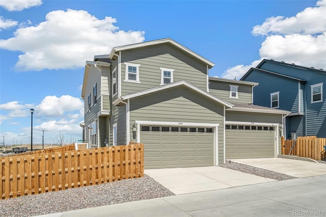 13458 E 111th Ave, Commerce City, CO 80022 - view of front of house featuring fence, concrete driveway, and a garage