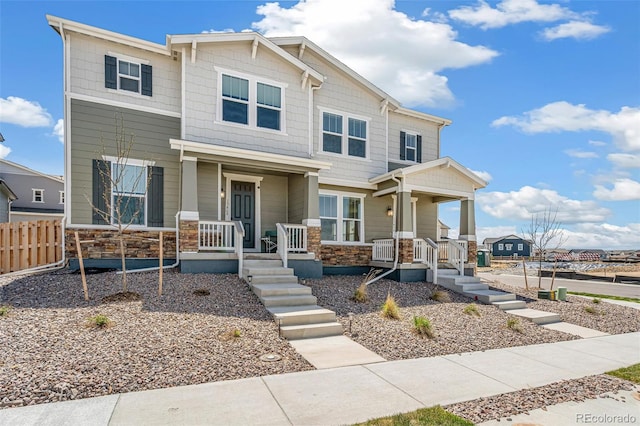 13458 E 111th Ave, Commerce City, CO 80022 - view of front facade featuring a porch, stone siding, and fence