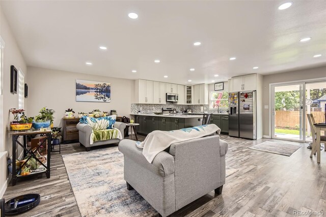 7465 S Ivy Way, Centennial, CO 80112 - living room with recessed lighting, light wood-type flooring, and baseboards