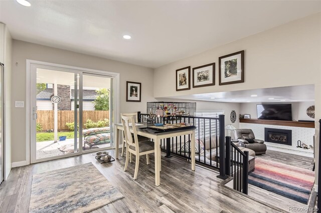 7465 S Ivy Way, Centennial, CO 80112 - dining room featuring wood finished floors, recessed lighting, and a brick fireplace