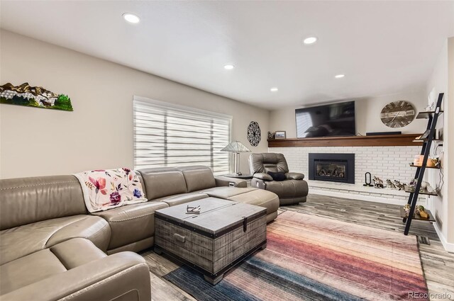 7465 S Ivy Way, Centennial, CO 80112 - living room with light wood finished floors, recessed lighting, and a brick fireplace