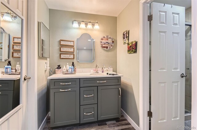 7465 S Ivy Way, Centennial, CO 80112 - bathroom with vanity, wood finished floors, and baseboards