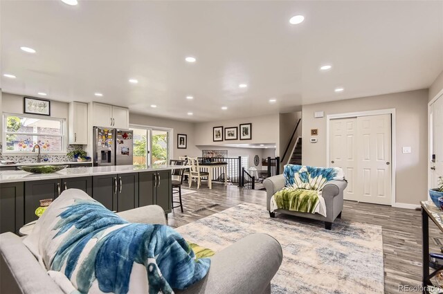 7465 S Ivy Way, Centennial, CO 80112 - living area with stairway, wood finished floors, recessed lighting, and baseboards