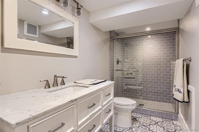 7465 S Ivy Way, Centennial, CO 80112 - bathroom with a shower stall, vanity, toilet, and tile patterned floors