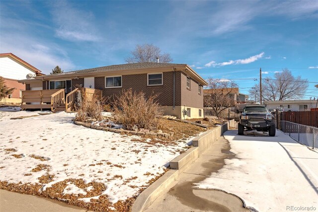 9486 Pelon Dr, Denver, CO 80260 - single story home with fence, a wooden deck, and driveway