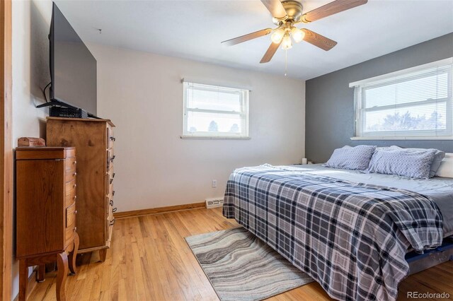 9486 Pelon Dr, Denver, CO 80260 - bedroom with multiple windows, light wood-style floors, baseboards, and ceiling fan