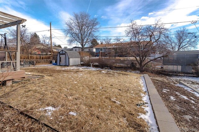 9486 Pelon Dr, Denver, CO 80260 - fenced backyard with a storage shed and an outbuilding