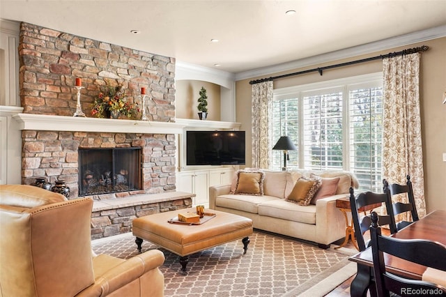 living room with crown molding and a stone fireplace