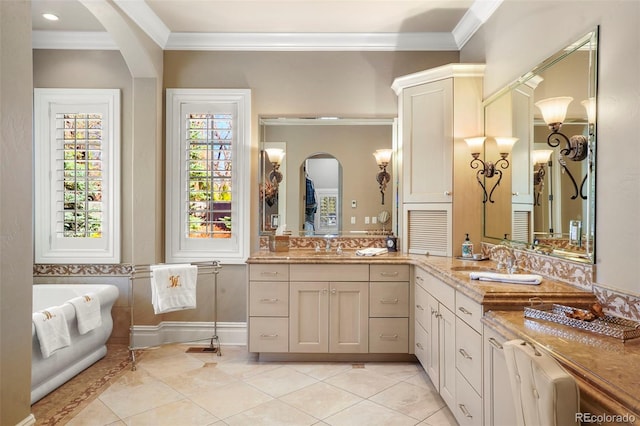 bathroom featuring a soaking tub, crown molding, vanity, and tile patterned floors