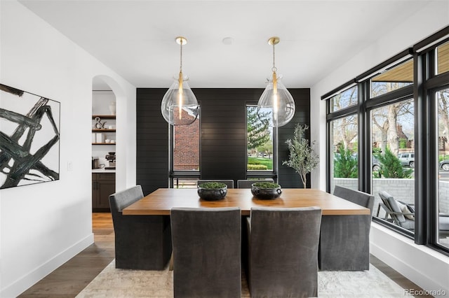 dining room featuring baseboards and dark wood finished floors