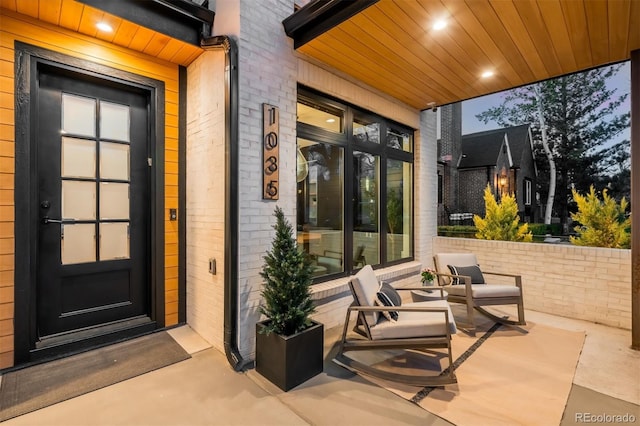 entrance to property featuring brick siding