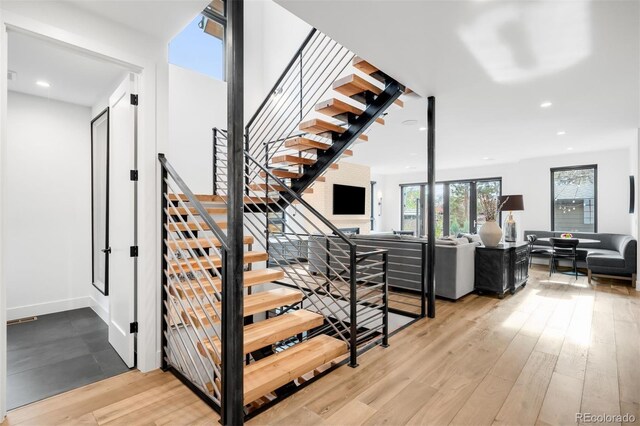 staircase with hardwood / wood-style flooring and recessed lighting