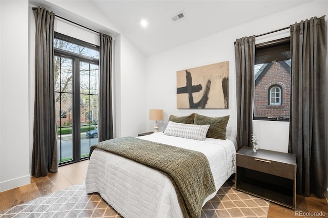 bedroom featuring visible vents, wood finished floors, lofted ceiling, and recessed lighting