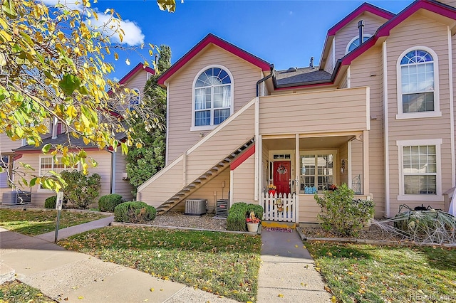 townhome / multi-family property with central air condition unit and stairs