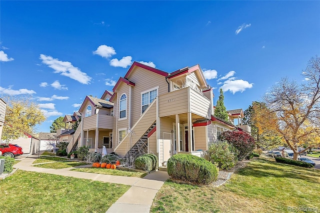 multi unit property with a front yard and stairs