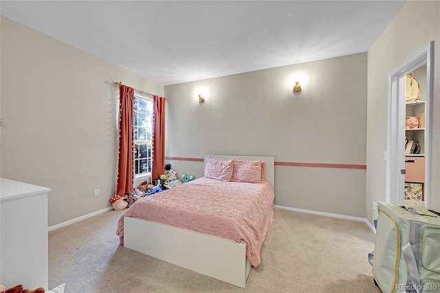 carpeted bedroom featuring baseboards