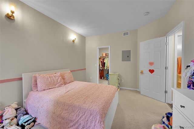 bedroom featuring light colored carpet, a spacious closet, electric panel, a closet, and baseboards
