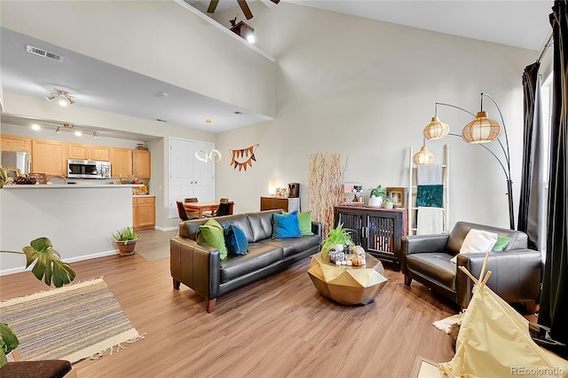 living area featuring light wood-style flooring and baseboards