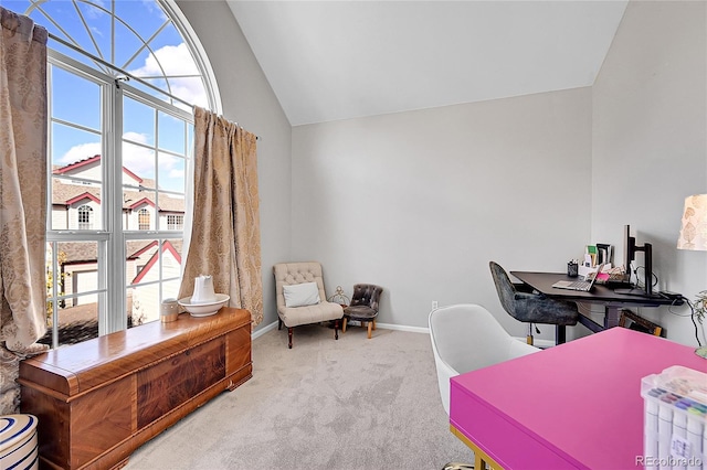 office space featuring carpet, vaulted ceiling, and baseboards