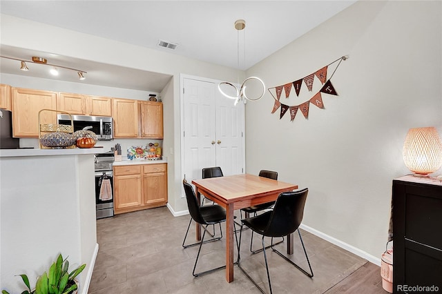 dining area with baseboards and light tile patterned floors