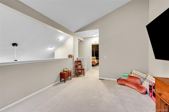 recreation room with carpet, vaulted ceiling, and baseboards