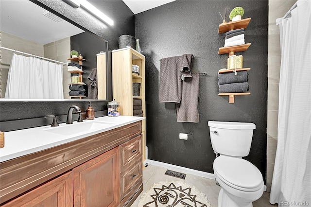 full bathroom featuring toilet, tile patterned floors, vanity, curtained shower, and a textured wall