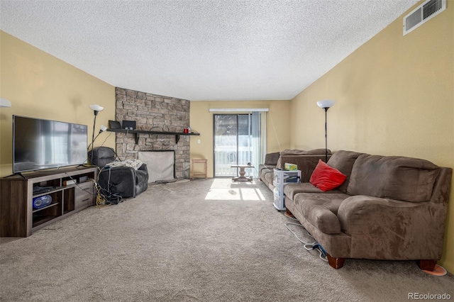 carpeted living room with a fireplace and a textured ceiling