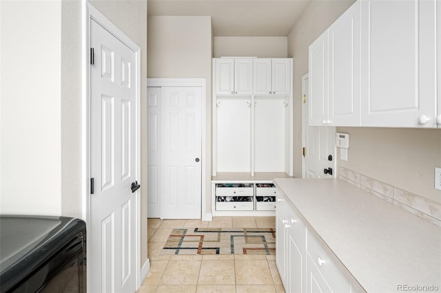 kitchen with light tile patterned floors, white cabinets, and light countertops