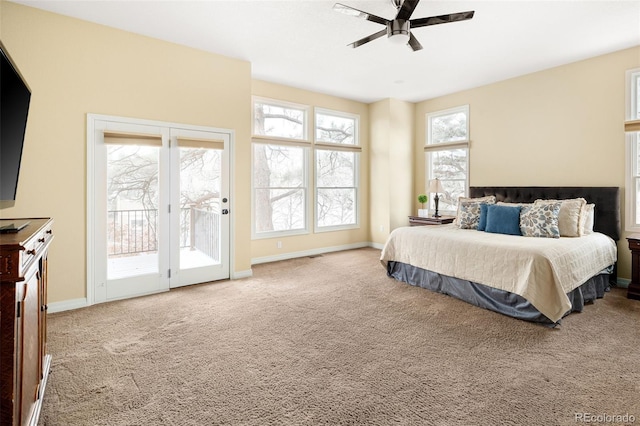 carpeted bedroom featuring access to outside, a ceiling fan, and baseboards